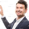 Smiling Man Showing Small Piece of Puzzle Stock Photo
