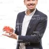 Smiling Male Character Presenting Piece Of Puzzle Stock Photo
