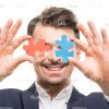 Smiling Man With Puzzles Stock Photo Isolated On White