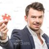 Good-Looking Man Holding Piece Of Puzzle Stock Photo