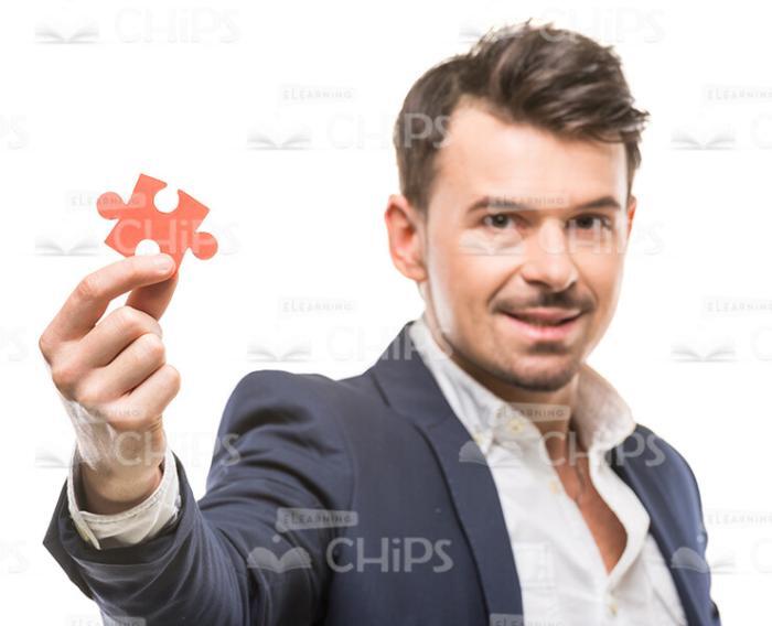 Good-Looking Man Holding Piece Of Puzzle Stock Photo