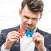 Man Connecting Puzzle Pieces White Background Stock Photo