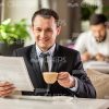 Happy Business Man Reading Newspapers Stock Photo