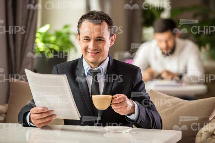 Happy Business Man Reading Newspapers Stock Photo