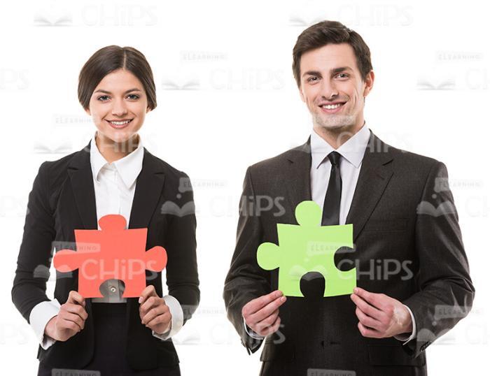 Businessman And Businesswoman With Puzzle Pieces Stock Photo On White Background