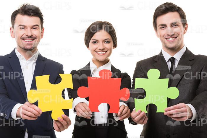 Business Team With Pieces Of Puzzle White Isolated Stock Photo