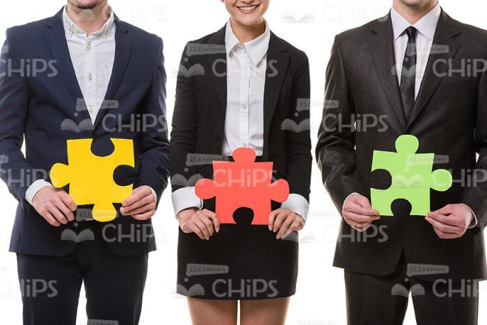 Business People On White Background Holding Puzzles Stock Photo