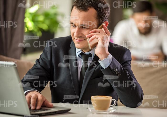 Business Man At Restaurant Using Laptop Stock Photo