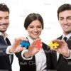 Smiling Business Team With Small Puzzle Pieces Stock Photo
