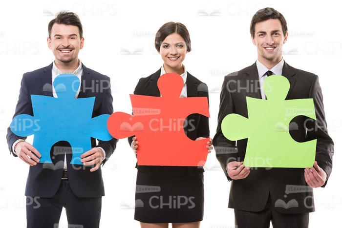 Young Business People With Big Jigsaw Pieces Stock Photo