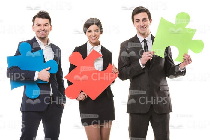 Young People Playing With Jigsaw Pieces Stock Photo