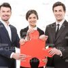 Business People Holding One Large Piece Of Jigsaw Stock Photo