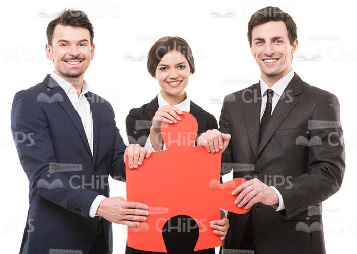 Business People Holding One Large Piece Of Jigsaw Stock Photo