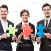 Business People Holding Puzzles Stock Photo