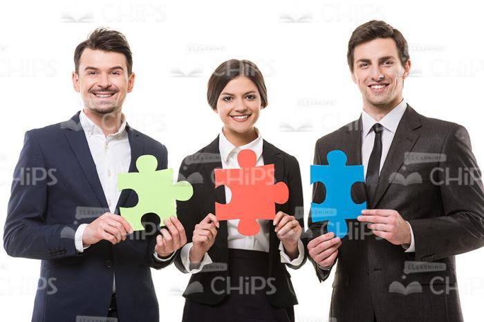 Business People Holding Puzzles Stock Photo