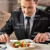 Handsome Businessman Eating Salad At Restaurant Stock Photo