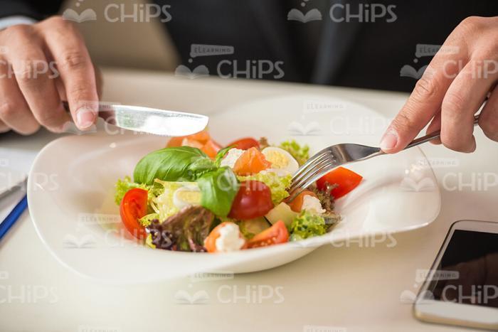 Close Up Stock Photo Of Salad And Man's Hands Holding Cutlery