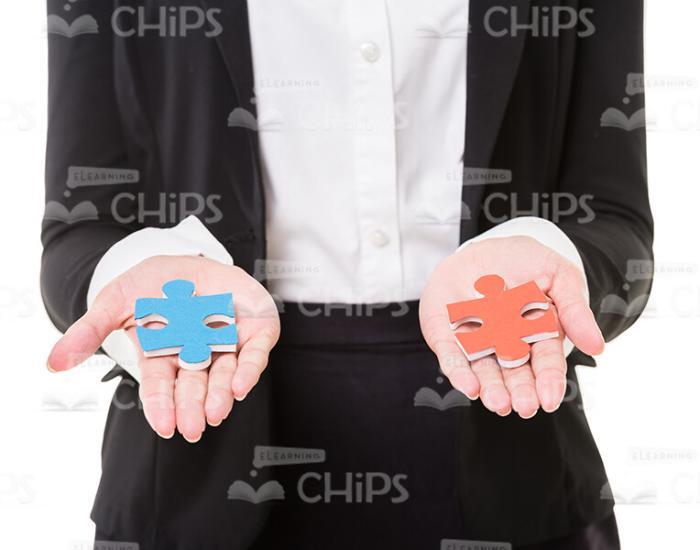 Colorful Jigsaw Puzzles In Woman's Hands Stock Photo