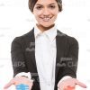 Smiling Business Woman Presenting Puzzles Stock Photo