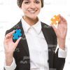 Smiling Business Woman Holding Puzzles Stock Photo