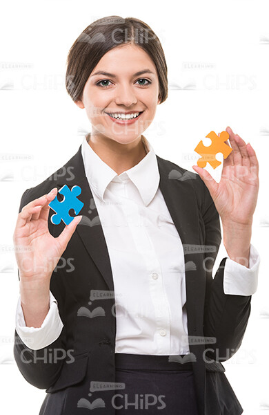 Smiling Business Woman Holding Puzzles Stock Photo