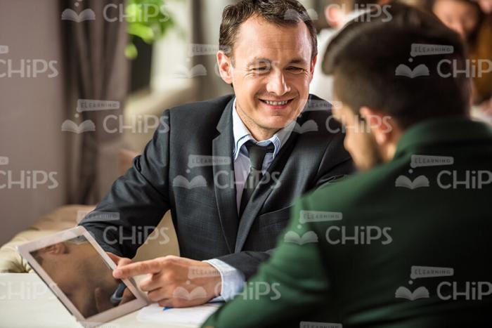 Businessmen Talking At Restaurant Stock Photo