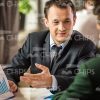 Businessman With Graphs Explaining Something To Colleague Stock Photo