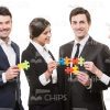 Four Business People Assembling Puzzles Stock Photo