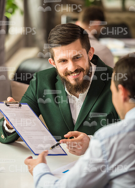 Smiling Man Holding Clipboard Stock Photo