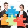 Young People Connecting Pieces Of Puzzle Stock Photo