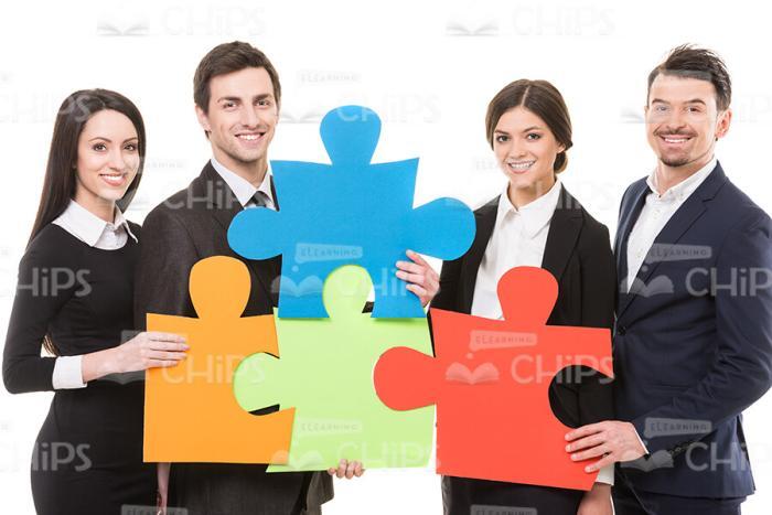 Young People Connecting Pieces Of Puzzle Stock Photo