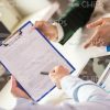 Man Pointing On Clipboard Stock Photo