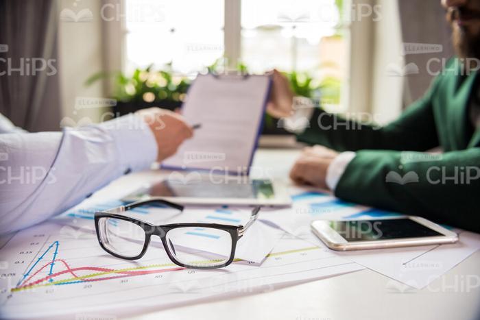 People's Hands Holding Clipboard Stock Photo