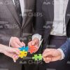 Small Pieces Of Puzzle In People Hands Stock Photo
