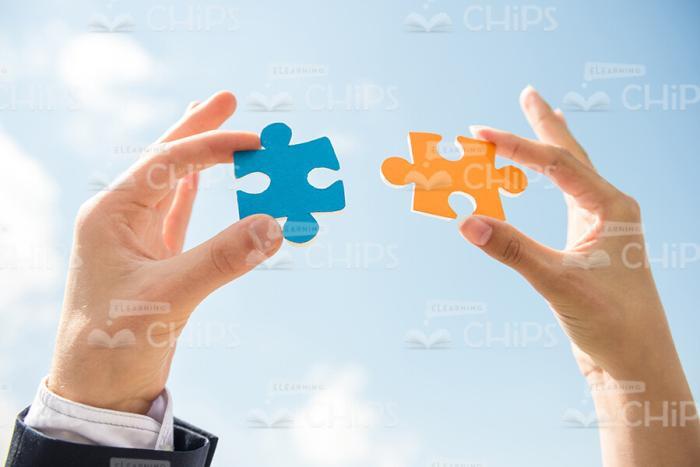 Two Pieces Of Puzzle In Men's Hands Stock Photo