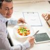 Satisfied Businessman Eating Salad Stock Photo