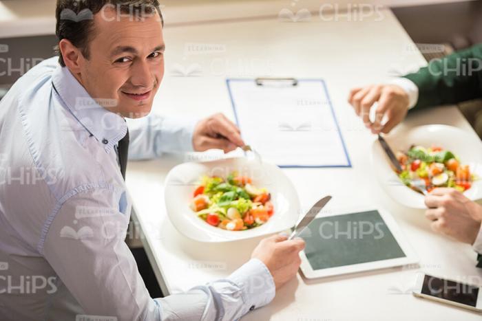 Satisfied Businessman Eating Salad Stock Photo