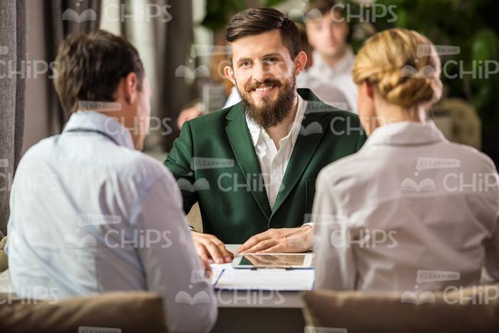 Three Business Partners At Meeting Stock Photo
