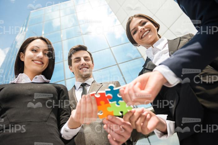 Young Business People Connects Pieces Of Puzzle Stock Photo