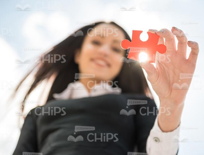 Red Jigsaw Puzzle In Woman's Hand Stock Photo