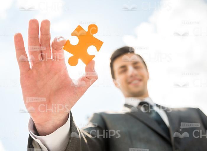 Piece Of Puzzle In Businessman's Hand Stock Photo