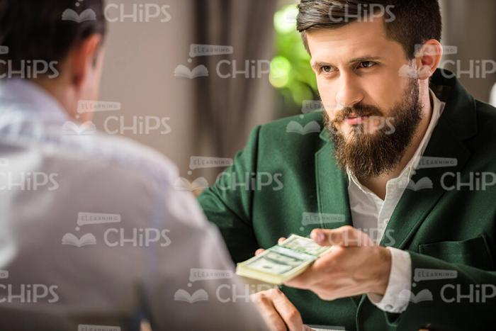 Businessman Giving Money To His Partner Stock Photo