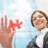 Young Businesswoman Holding Red Piece Of Puzzle Stock Photo