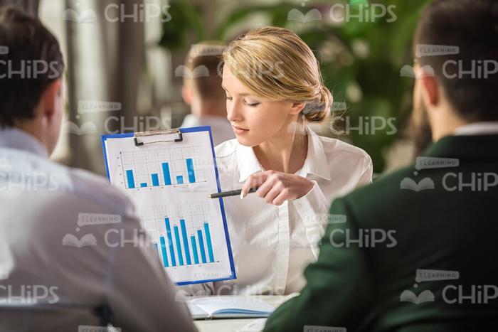 Young Woman With Clipboard Showing Charts Stock Photo