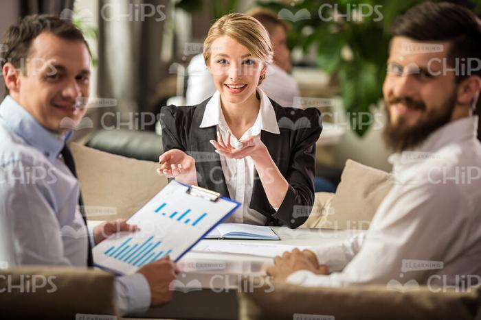 Stock Photo Of Business Team With Clipboard Turns To Camera