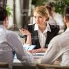 Young Businesswoman Talking With Partners Stock Photo