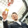 Confident Businessman Holding Puzzle Piece Stock Photo