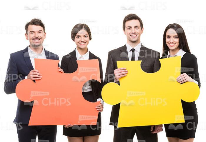 Young Business People With Two Big Pieces Of Puzzle Stock Photo