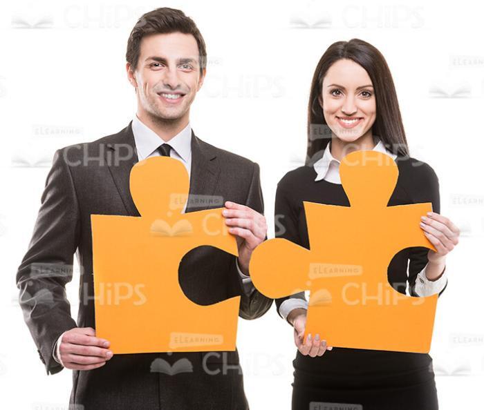 Man And Woman Holding Big Pieces Of Puzzle Stock Photo