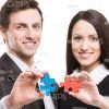 Smiling People Holding Small Pieces Of Puzzle Stock Photo